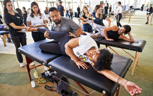 Dance Resource Center's Dancer Day of Health medical expert evaluating black female dancer.