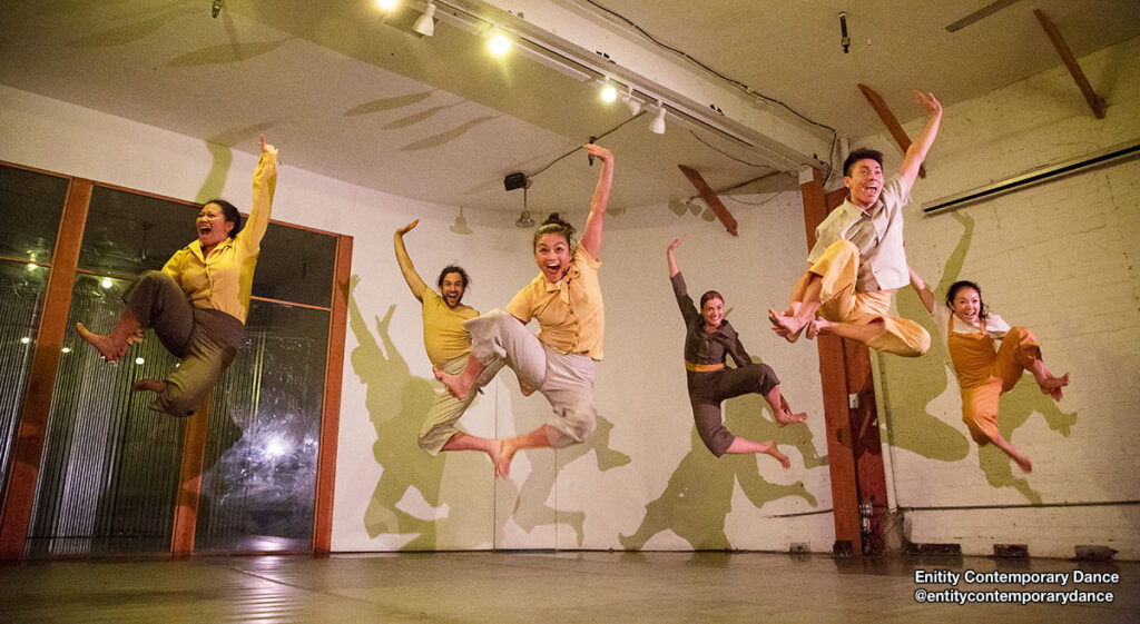 Dancers from @entitycontemporarydance jumping in the air.