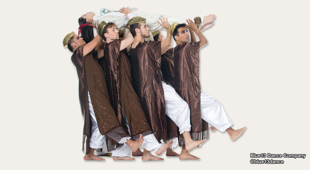 Group of male dancers from @blue13dance carrying another dancer horizontally.